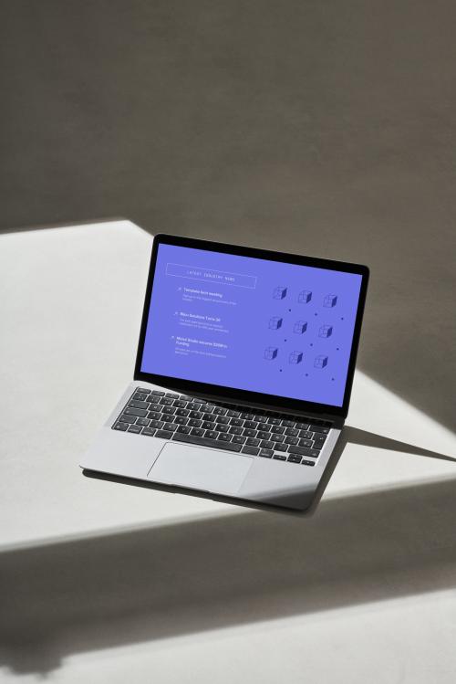 Metallic Laptop on a Concrete Surface with Shadows - 478873550