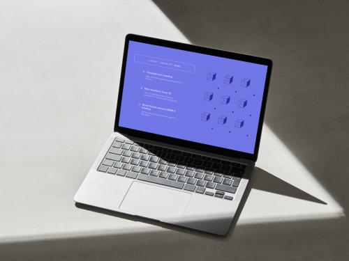 Silver Laptop on a Grey Surface with Hard Shadows - 478873555