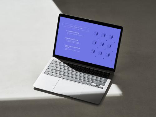 Laptop with Hard Shadow Lines on a Concrete Surface - 478873556