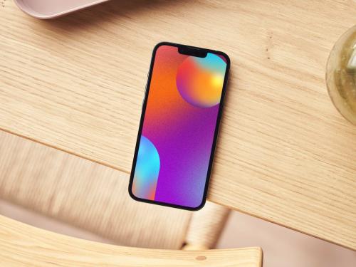 Top View of a Smartphone on a Wooden Table Mockup