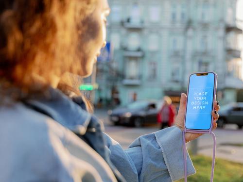 Phone 12 Pro Max Mockup in Woman's Hand