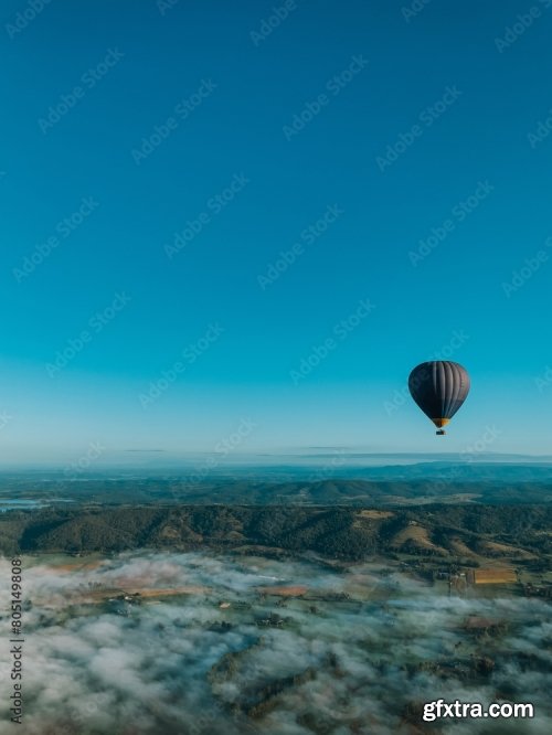 Hot-Air Balloon Flying Over The Hills And Mountains Above The Clouds 6xJPEG