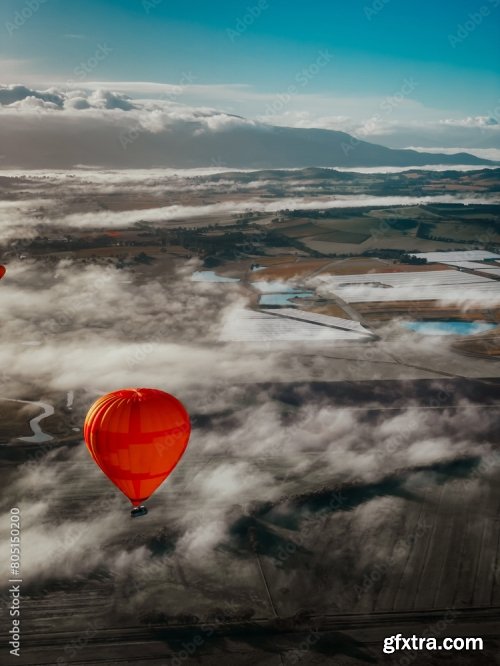 Hot-Air Balloon Flying Over The Hills And Mountains Above The Clouds 6xJPEG