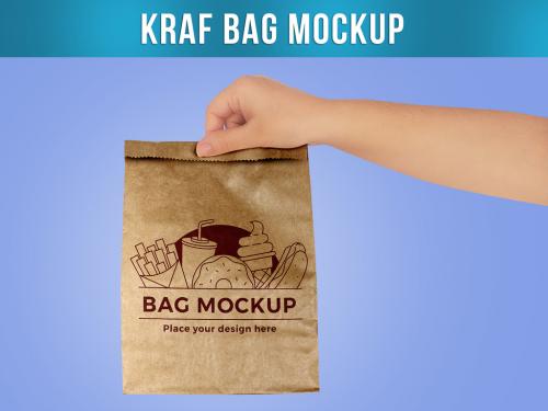 Hand Holding a Paper Kraf Bag Mockup