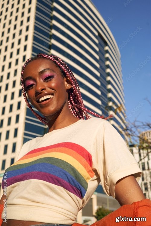 Portrait Of Young Non-Conforming With Braids Smiling In The City 6xJPEG
