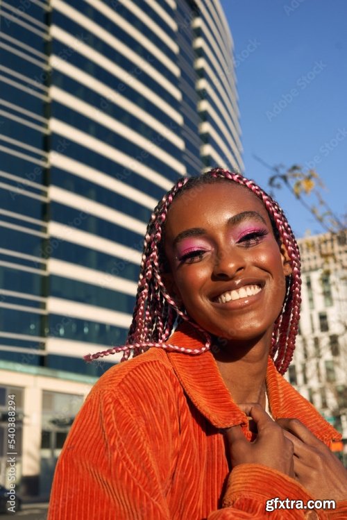 Portrait Of Young Non-Conforming With Braids Smiling In The City 6xJPEG
