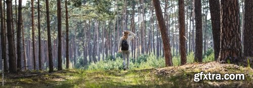 Woman With Hat And Backpack Hiking On Footpath In Forest 6xJPEG