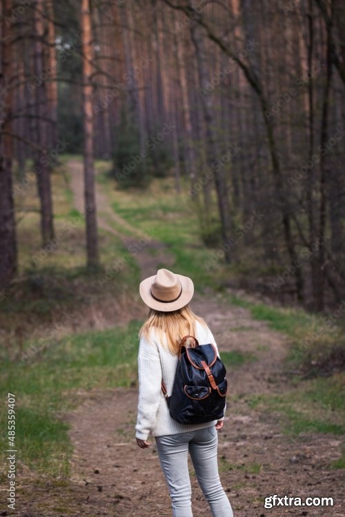 Woman With Hat And Backpack Hiking On Footpath In Forest 6xJPEG