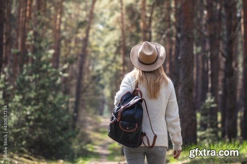 Woman With Hat And Backpack Hiking On Footpath In Forest 6xJPEG