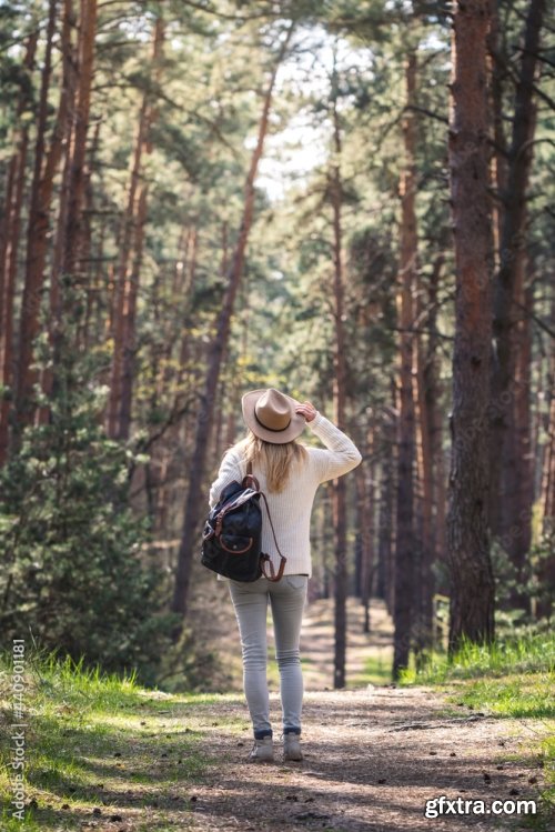 Woman With Hat And Backpack Hiking On Footpath In Forest 6xJPEG