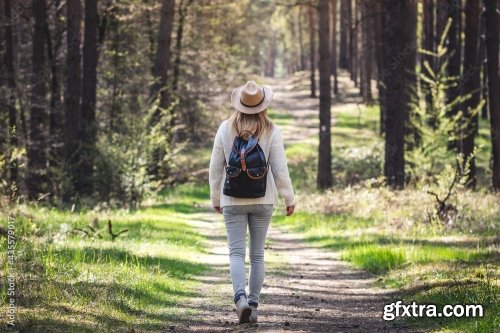 Woman With Hat And Backpack Hiking On Footpath In Forest 6xJPEG