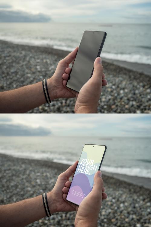 Modern Smartphone mockup in men's hand on the beach