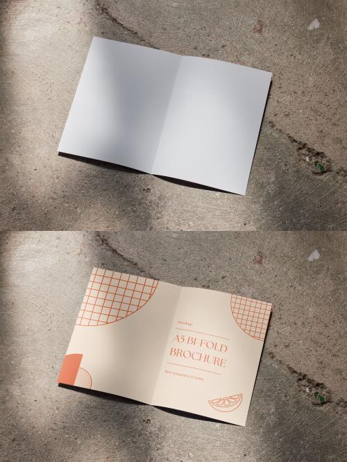 A5 Brochure Mockup Open on a Concrete Floor