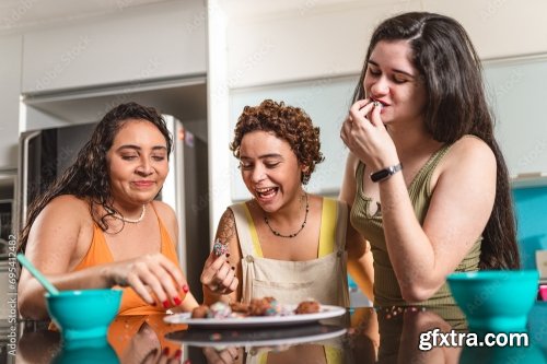 Young Women In The Kitchen Eating Tapioca Dice, A Traditional Snack From Brazil 5xJPEG