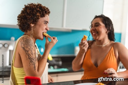 Young Women In The Kitchen Eating Tapioca Dice, A Traditional Snack From Brazil 5xJPEG