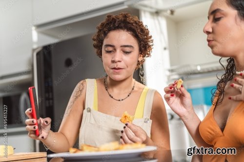 Young Women In The Kitchen Eating Tapioca Dice, A Traditional Snack From Brazil 5xJPEG