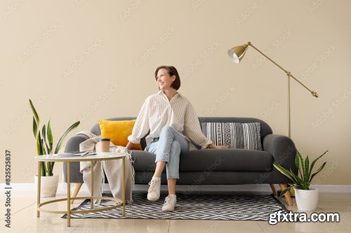 Young Pretty Woman Sitting On Sofa In Living Room 6xJPEG