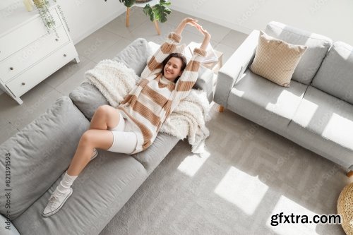 Young Pretty Woman Sitting On Sofa In Living Room 6xJPEG