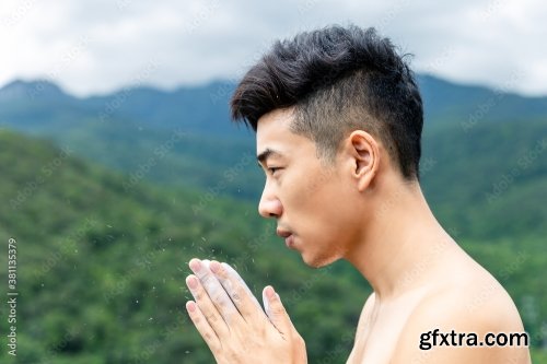 Asian Man Rock Climber In Black Pants Climbing On The Cliff 6xJPEG