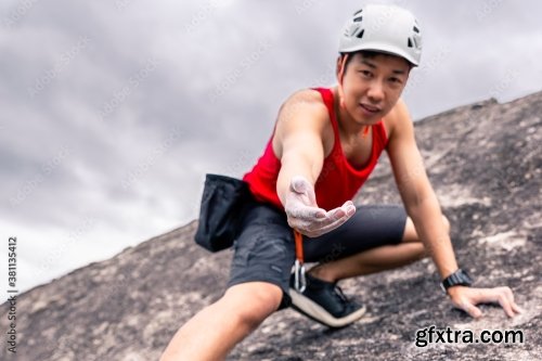 Asian Man Rock Climber In Black Pants Climbing On The Cliff 6xJPEG