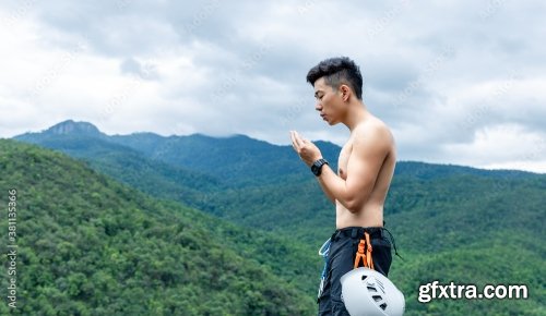 Asian Man Rock Climber In Black Pants Climbing On The Cliff 6xJPEG