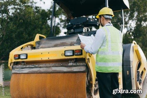 Engineer Looking Blueprint Of Project Near 7xJPEG