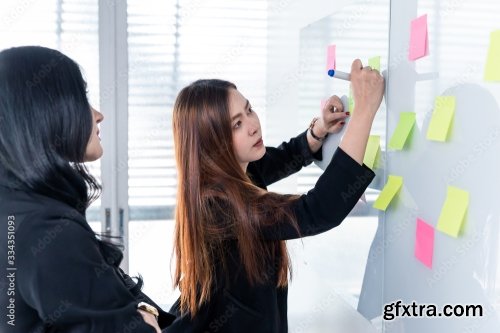 Business Woman Using Post It Note On Glossy White Board 4xJPEG