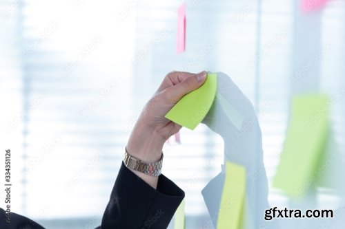 Business Woman Using Post It Note On Glossy White Board 4xJPEG