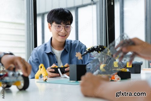 Asian Teenager Constructing Robot 7xJPEG