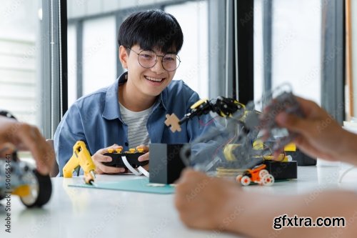 Asian Teenager Constructing Robot 7xJPEG